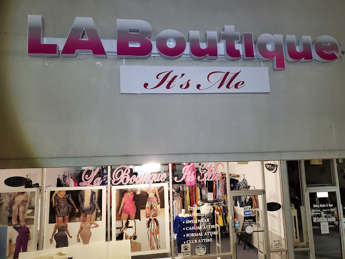 Pink channel letters and a script panel above a boutique storefront