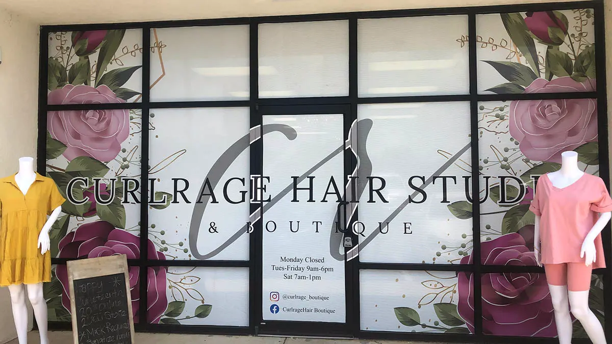 Boutique windows covered in printed floral graphics and lettering