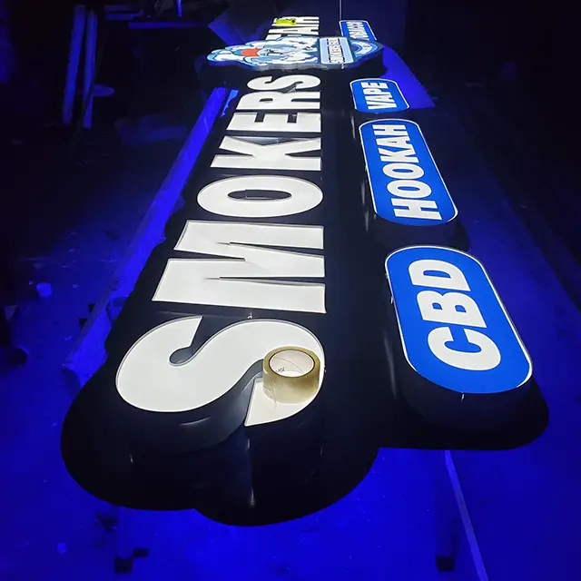 LED light test on Smoker's Fair channel letter sign in workshop | Outdoor Signage | Channel Letters | Sparks Sign Company