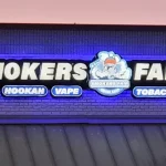 Smoker's Fair backlit channel letter sign on raceway, illuminated at dusk | Outdoor Signage | Sparks Sign Company