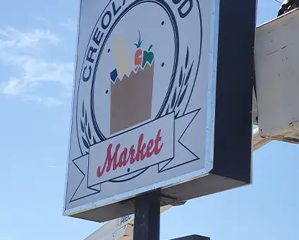 Creola Food Mart Rectangular Sign on Pole with Truck bucket | Pylon Signs | Sparks Sign Company