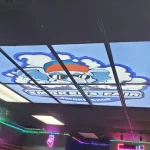 Illuminated ceiling tile indoor signage with Smoker's Fair logo across grid | Indoor Signage | Sparks Sign Company
