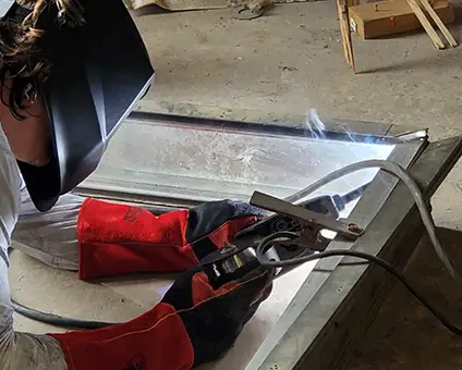 Welding aluminum frame in our workshop | Monument Signs | Sparks Sign Company