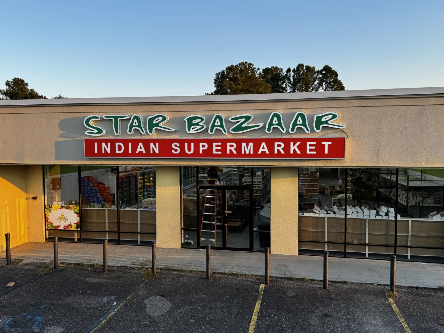 Star Bazaar channel letters over a red Indian Supermarket cabinet sign on a storefront