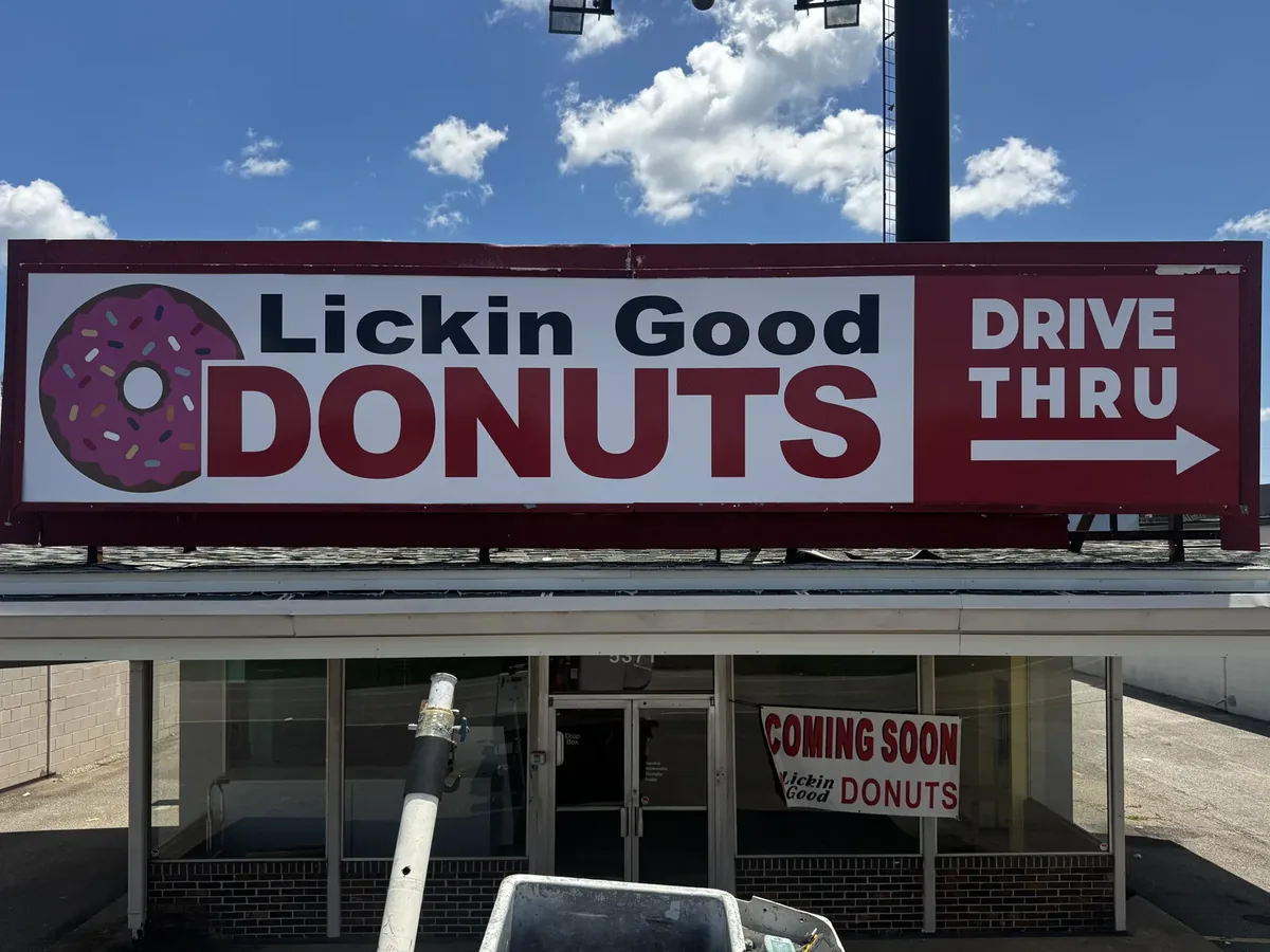 The same rooftop sign cabinet with its new Lickin Good Donuts Drive Thru face in