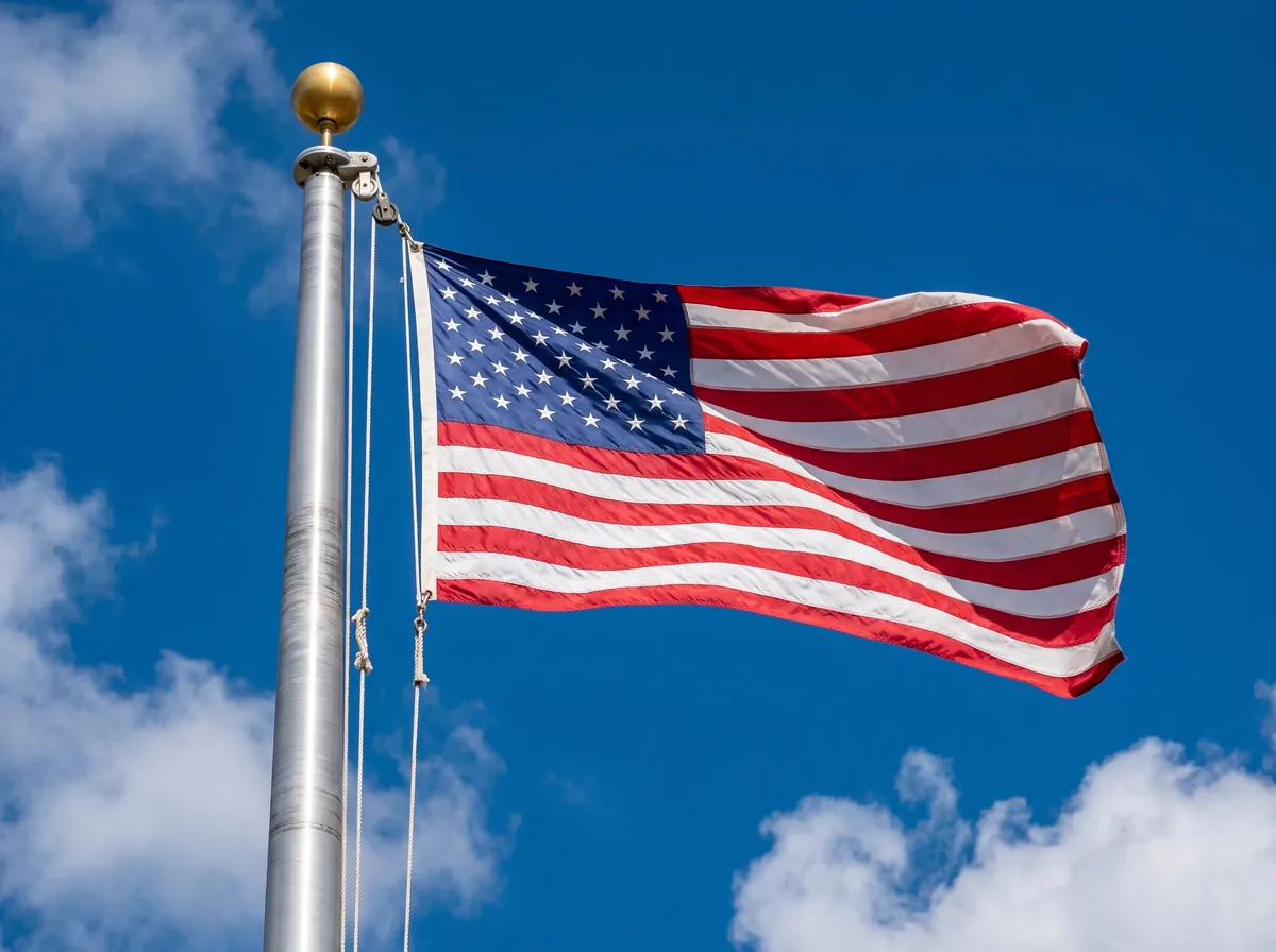 Generated illustration of the top of an aluminum flagpole, showing the ball finial, the pulley truck and the halyard ropes holding a United States flag
