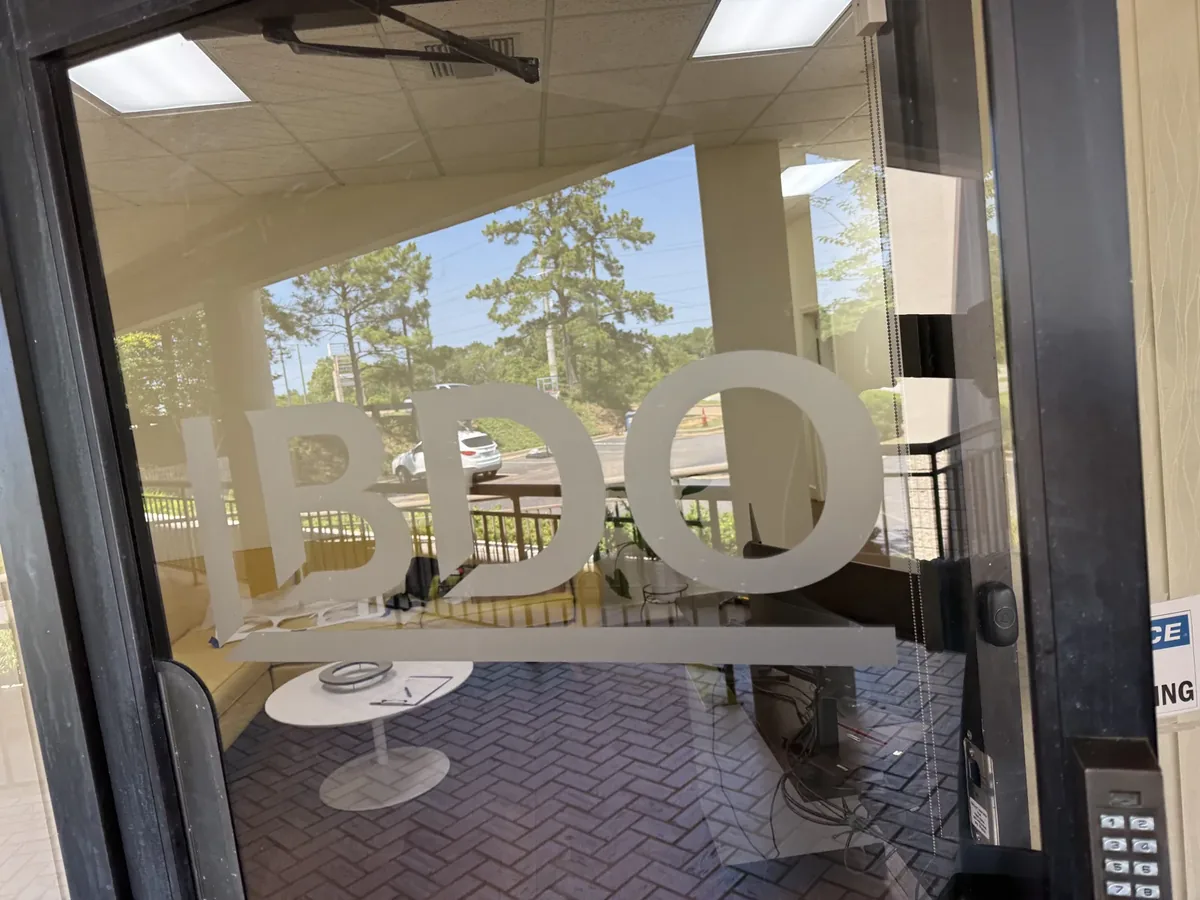 The same company logo in frosted vinyl on the office glass entry door