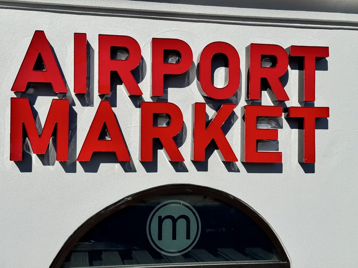 Airport Market red channel letters on the storefront above an arched window