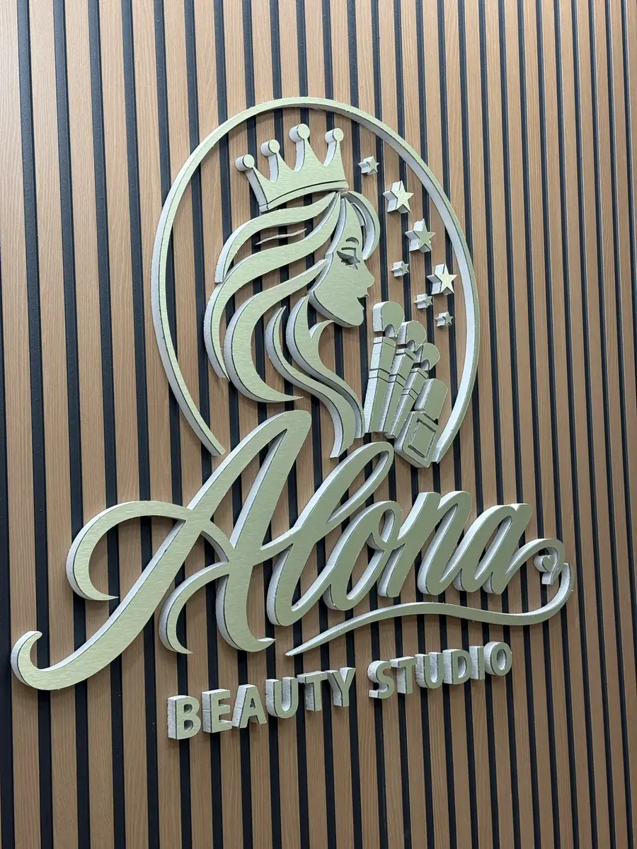Alona Beauty Studio dimensional logo sign on a slatted wood wall