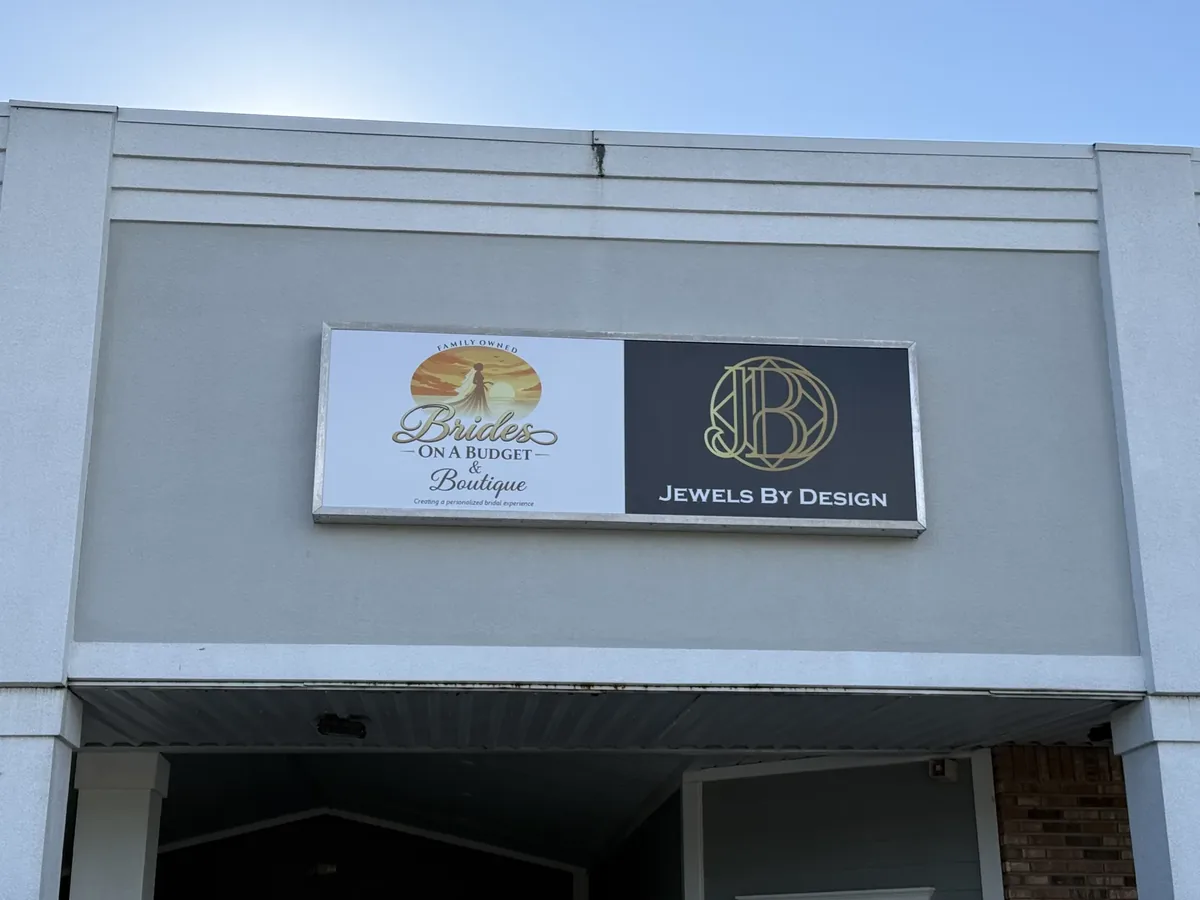 Brides on a Budget & Boutique and Jewels By Design wall cabinet sign on the storefront fascia