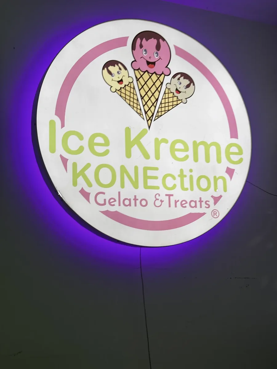 Ice Kreme KONEction round lit logo sign with a purple halo glow