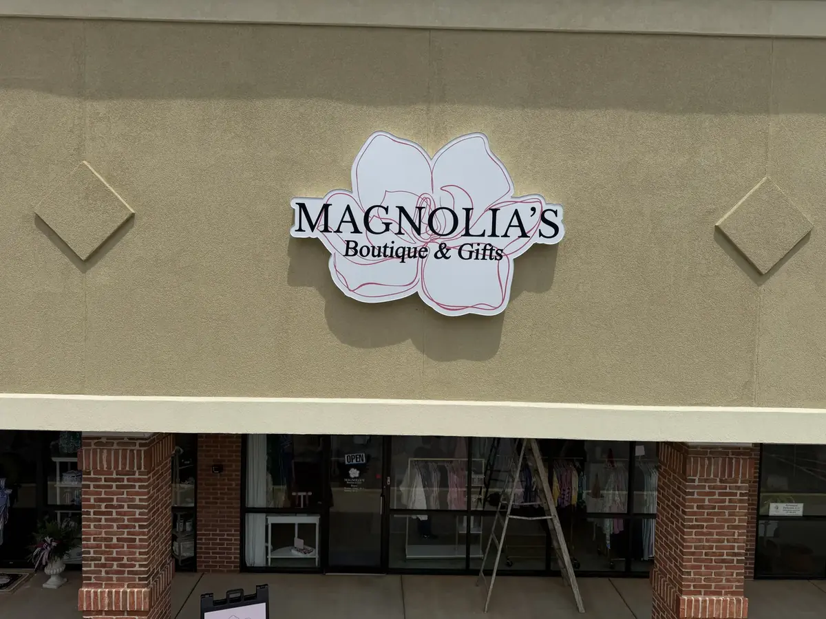 Magnolia's Boutique & Gifts shaped magnolia flower sign above the storefront
