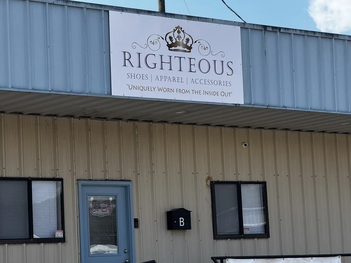 Righteous Shoes, Apparel and Accessories flat sign panel above the door of a metal building