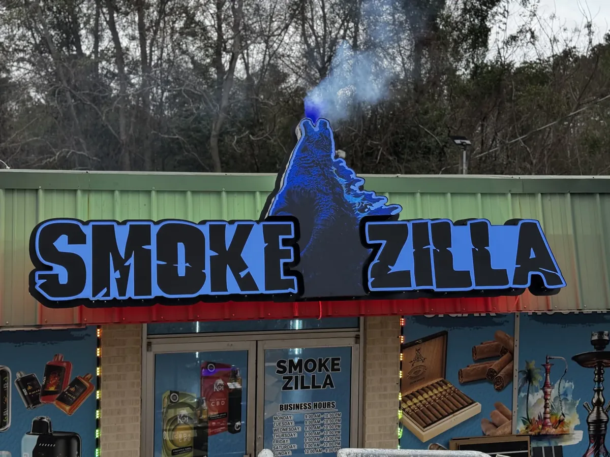 Smoke Zilla monster sign above the storefront with smoke rising and wrapped windows