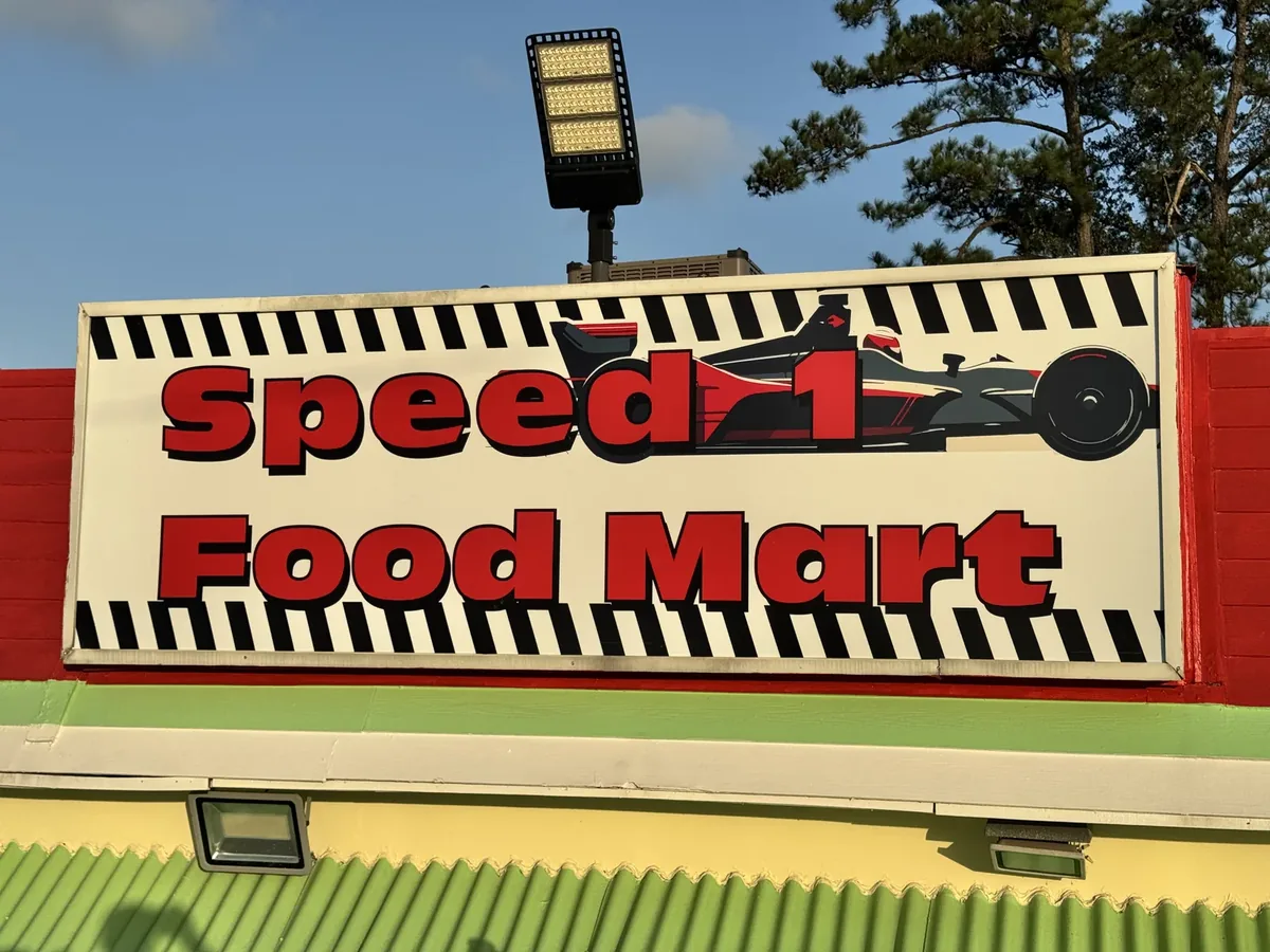 Speed 1 Food Mart race car sign panel on the building
