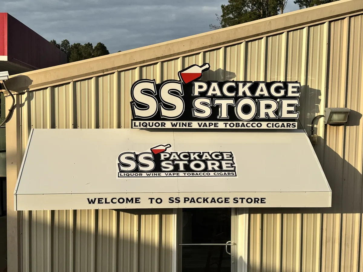 SS Package Store sign on a metal building above a printed awning