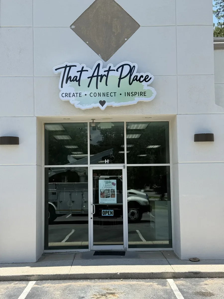 That Art Place contour-cut wall sign above the glass entry
