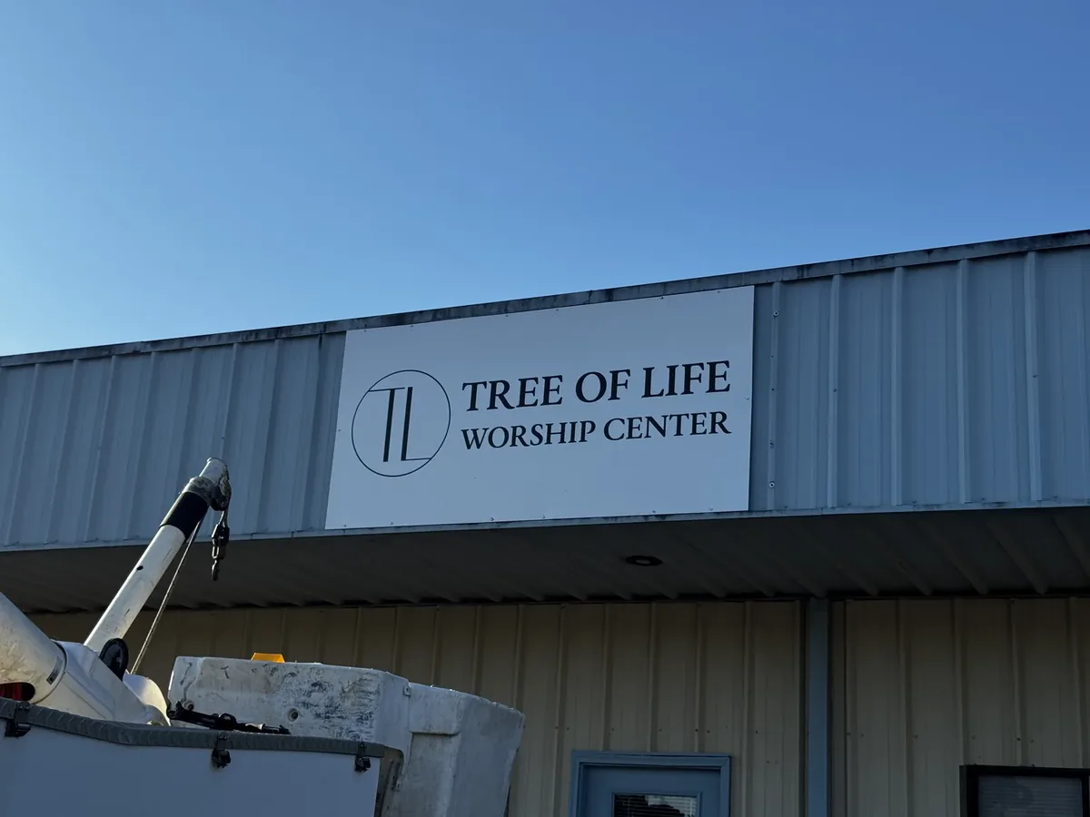 Tree of Life Worship Center flat sign panel on a metal building